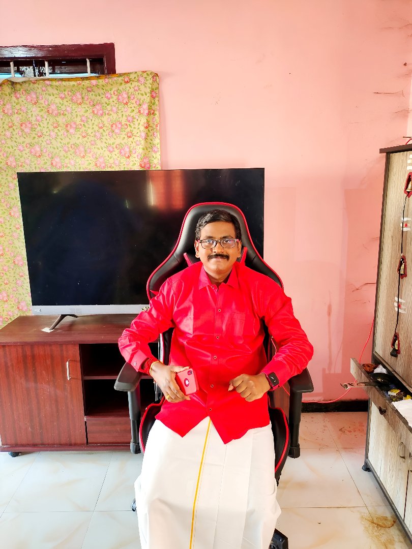 Mr Gowtham Raj holding tablet wearing black shirt smiling engaging